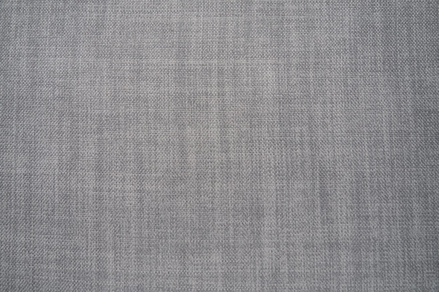 Texture de tissu de fond gris Un morceau de tissu de laine est soigneusement disposé sur la surface Texture de tissage et textile Tissu vestimentaire ou pour les besoins de la cuisine nappe ou rideaux gros plan