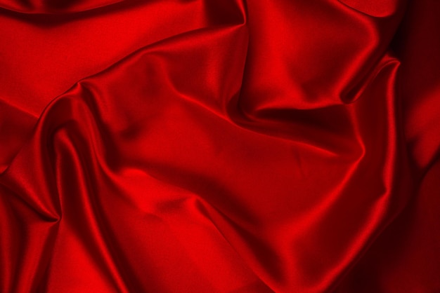 La texture de tissu de luxe en soie rouge ou en satin peut être utilisée comme arrière-plan abstrait Vue de dessus