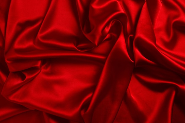 Photo la texture de tissu de luxe en soie rouge ou en satin peut être utilisée comme arrière-plan abstrait vue de dessus
