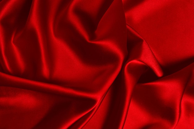 La texture de tissu de luxe en soie rouge ou en satin peut être utilisée comme arrière-plan abstrait Vue de dessus