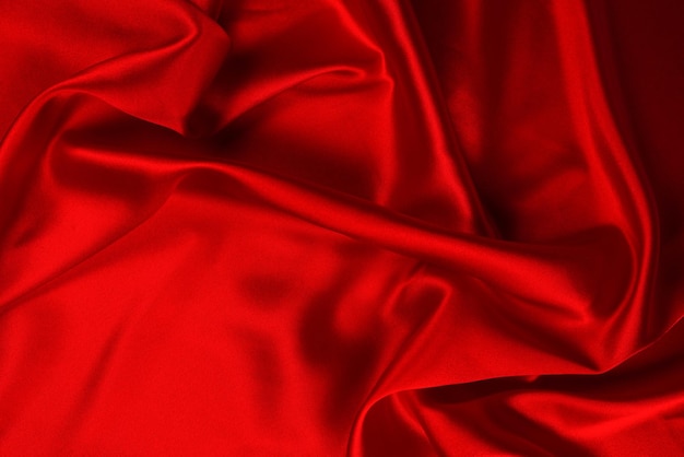 La texture de tissu de luxe en soie rouge ou en satin peut être utilisée comme arrière-plan abstrait Vue de dessus