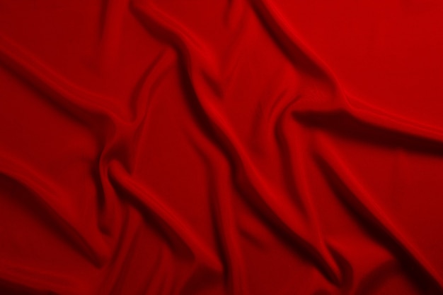 La texture de tissu de luxe en soie rouge ou en satin peut être utilisée comme fond abstrait