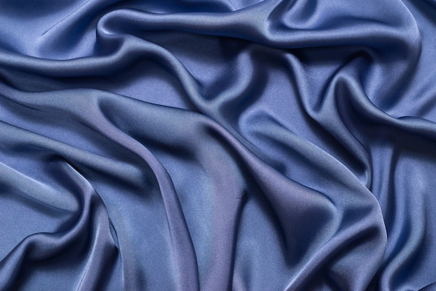 Texture de tissu de luxe en soie ou satin bleu