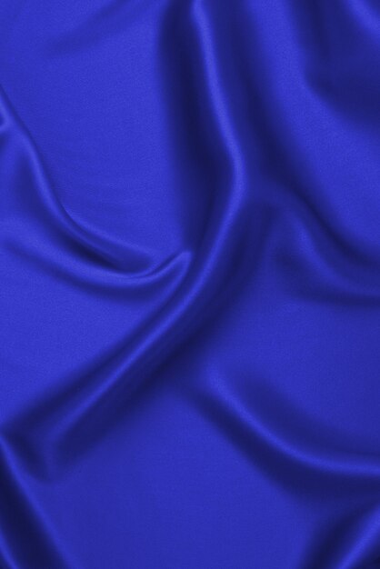 La texture de tissu de luxe en soie violette ou en satin peut être utilisée comme arrière-plan abstrait Vue de dessus