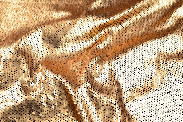 Texture de tissu de paillettes dorées.