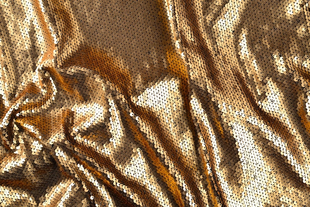 Texture de tissu de paillettes dorées.