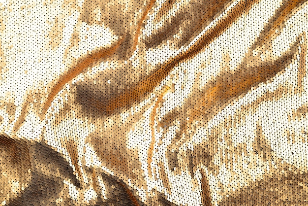 Texture de tissu de paillettes dorées.