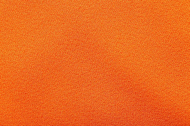 Texture de tissu synthétique orange comme gros plan d'arrière-plan