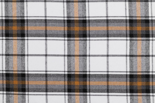 Texture de tissu tartane dans les couleurs blanc jaune et noir Vêtements traditionnels écossais Arrière-plan pour votre conception