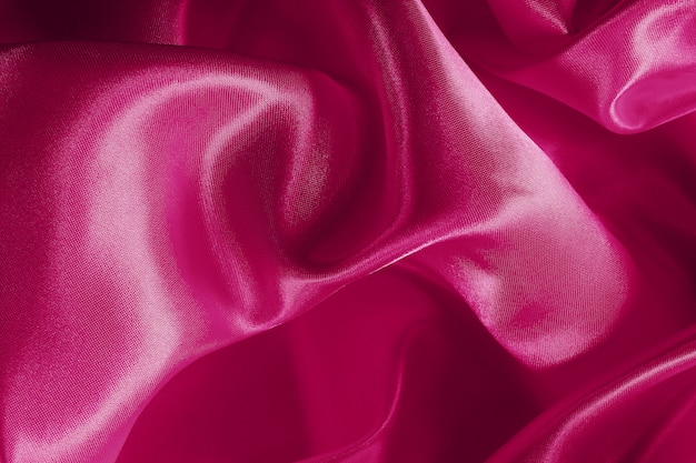 Texture de tissu de tissu rose pour le fond et la conception artistique, beau motif froissé de soie ou de lin.