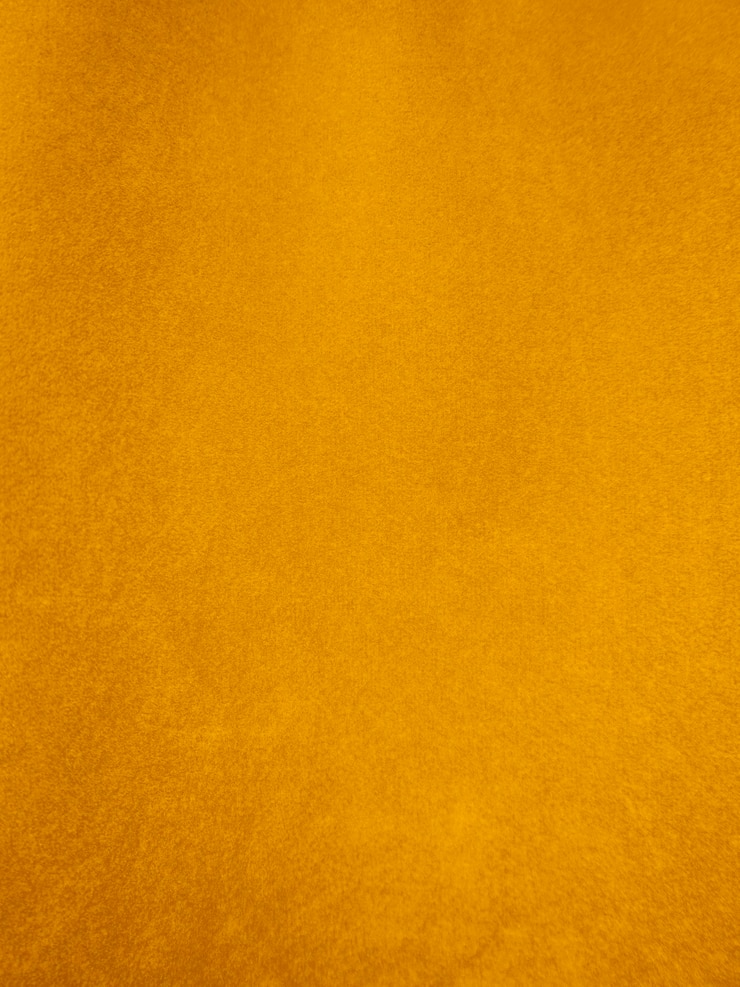 Photo texture de tissu de velours jaune utilisée comme arrière-plan fond de tissu jaune vide de matière textile douce et lisse il y a de l'espace pour le texte