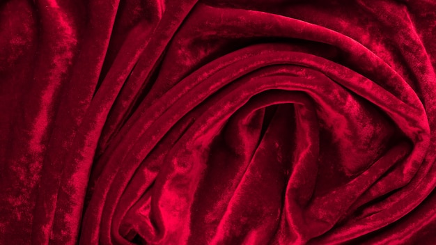 Texture de tissu de velours rouge avec des plis se bouchent