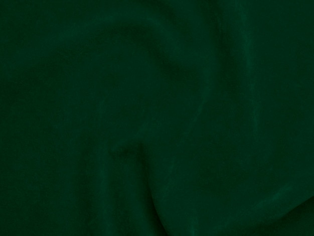 Texture de tissu de velours vert foncé utilisé comme arrière-plan Fond de tissu vert vide de matière textile douce et lisse Il y a de l'espace pour le texte