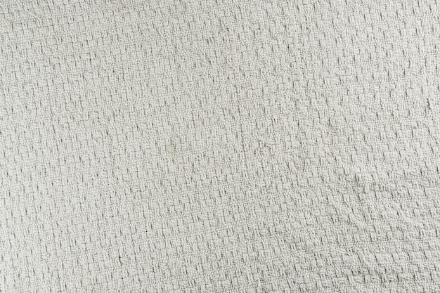 Texture de tissu volumineux avec des détails. Couleur grise, utilisée comme couverture, repose-canapé.