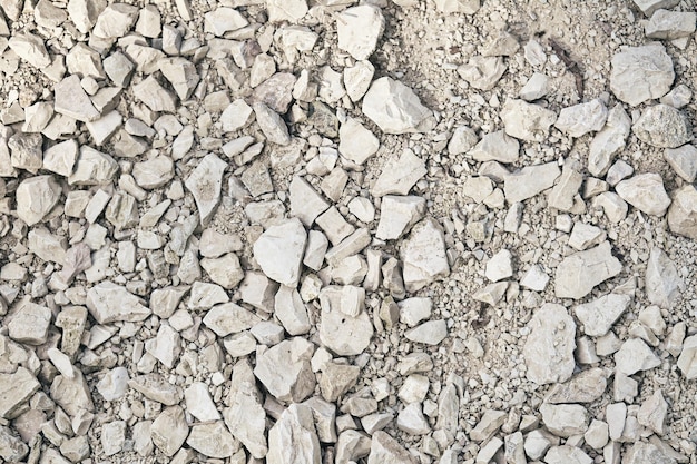 Texture de tombe de route pour le fond Pierre concassée blanche Vue de dessus du chemin de terre Terre sèche avec des pierres