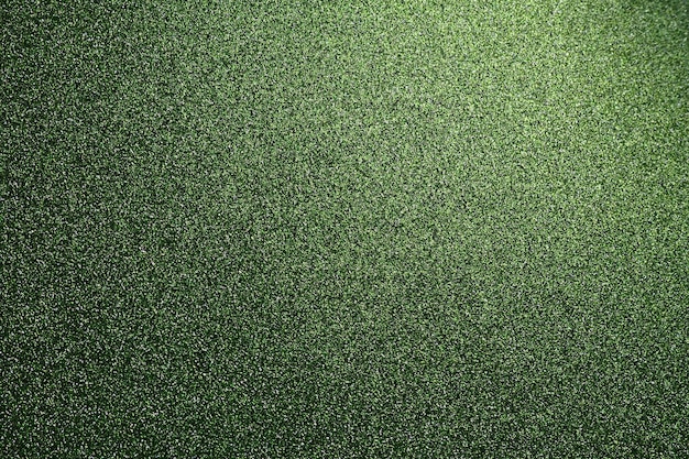 Texture verte herbeuse profonde de papier rugueux ou de carton défocalisé bokeh scintille et brille sur le