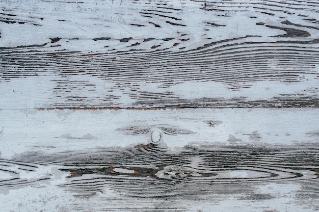 Texture d'une vieille planche avec de la peinture blanche écaillée