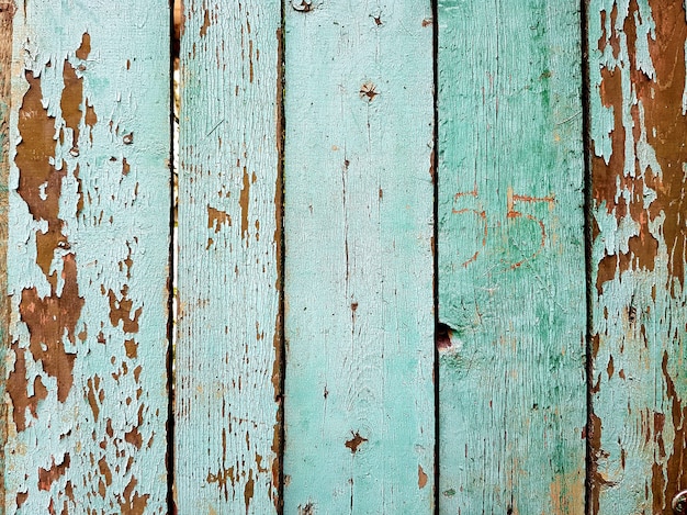 Texture de vieilles planches peintes. Gros plan sur les vieux panneaux de clôture en bois vert