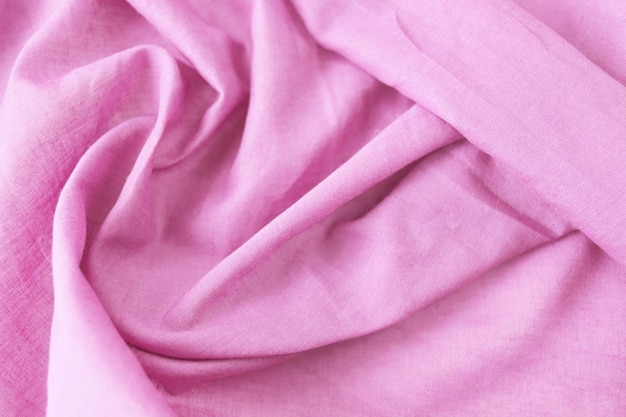 La texture de la vue de dessus de plis de coton en tissu naturel rose