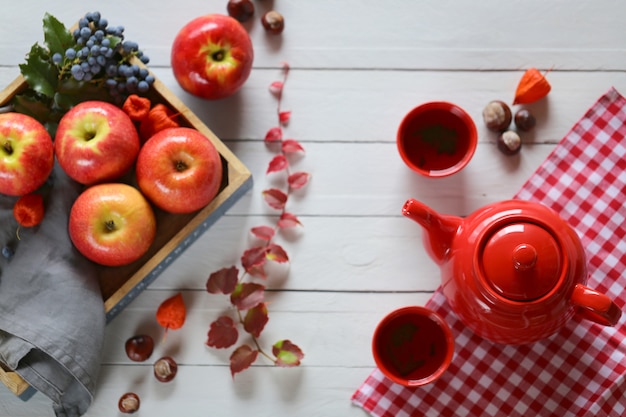 Thé d'automne. théière avec une tasse de thé sur un fond en bois bleu