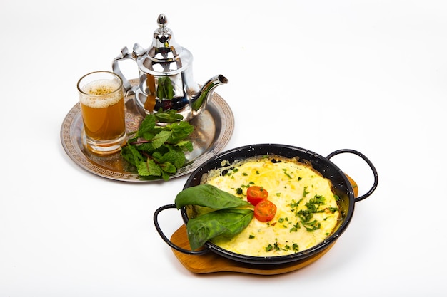 thé de petit-déjeuner traditionnel marocain à la menthe et aux herbes d'omelette et à la tomate
