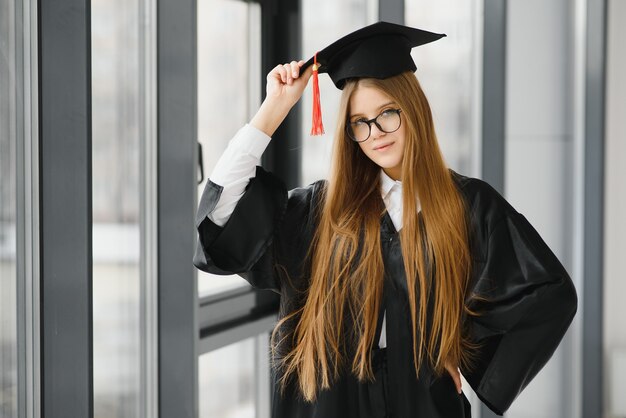 Thème éducatif: étudiante diplômée en robe académique.