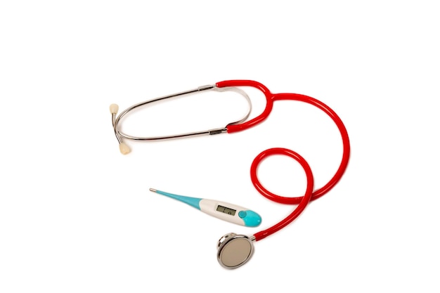 Thermomètre stéthoscope rouge isolé sur fond blanc Mise à plat avec différents objets de médecin fournitures d'équipement sur isolement blanc Espace de copie rapproché Concept médical et cardiologique