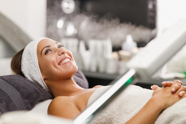 Tiré d'une belle jeune femme sur un soin du visage au salon de beauté.