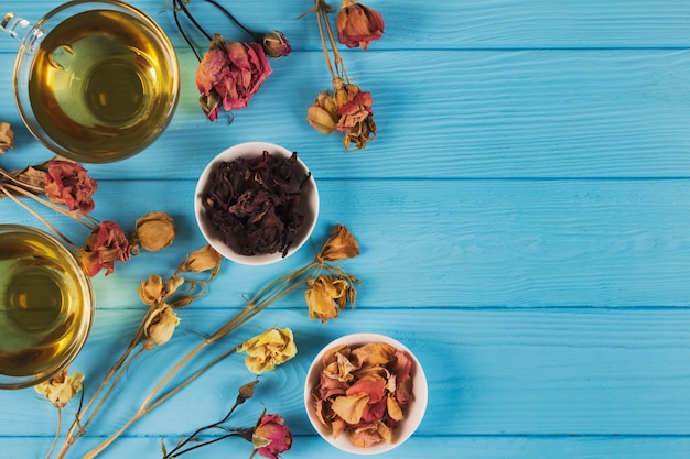 Tisane et fleurs séchées sur table bleue