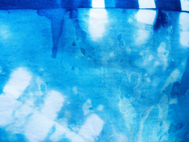 Photo tissu bleu indigo tie dye motif de fond. texture de tissu teint à l'indigo avec motif graphique ethnique abstrait.