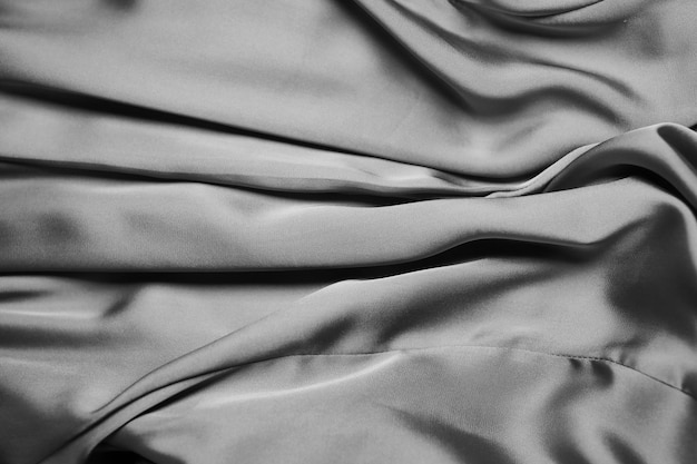 Le tissu est en soie Draperie en soie La soie est beige Le fond en tissu photo noir et blanc