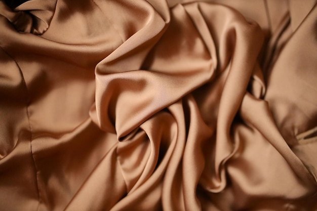 Le tissu est de texture de soie Draperie de soie La soie est de texture beige Le fond de tissu