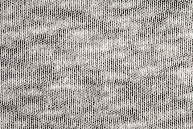 Tissu en laine tricoté, fils blancs, structure d'arrière-plan, vue macro en gros plan