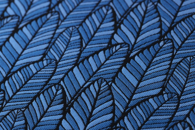 Tissu lisse bleu avec fond texturé imprimé feuilles élégantes