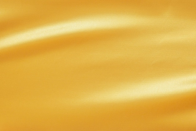 Tissu d'or de luxe abstrait avec fond de texture de vague douce