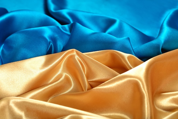Tissu de satin naturel doré et bleu comme texture de fond