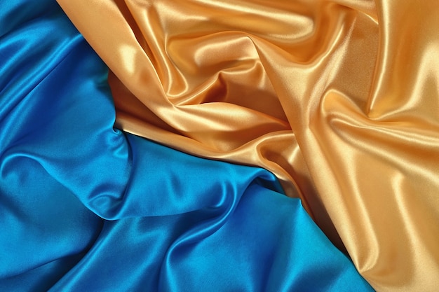 Tissu de satin naturel doré et bleu comme texture de fond