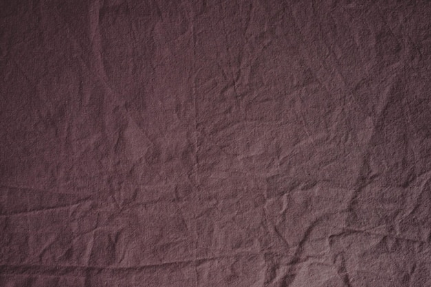 Tissu texturé de couleur rose poudré. Lit froissé. Texture coton. Matière rose.