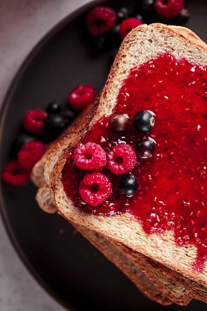 Toast avec de la confiture de framboises sur le dessus