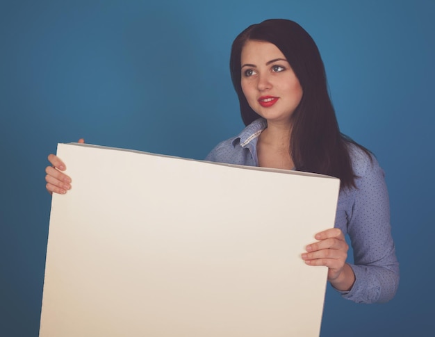 La toile est tenue par une belle femme sur fond bleu