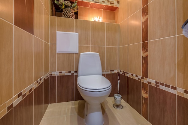 Toilettes et détail d'une cabine de douche d'angle avec fixation murale pour douche
