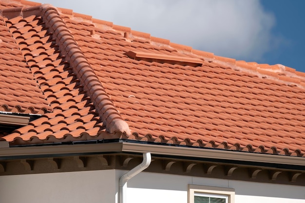 Le toit de la maison est recouvert de bardeaux en céramique jaune Revêtement en tuiles d'un immeuble d'appartements résidentiels