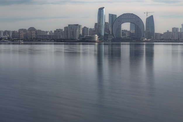 Toits de la ville moderne avec des gratte-ciel sur un front de mer reflète dans l'eau encore Bakou Azerbaïdjan