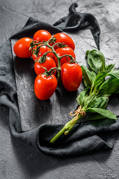 Tomates cerises sur basilic NOIR. Vue de dessus.