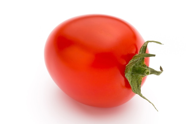 Tomates cerises. Trois tomates cerises sur une surface blanche.