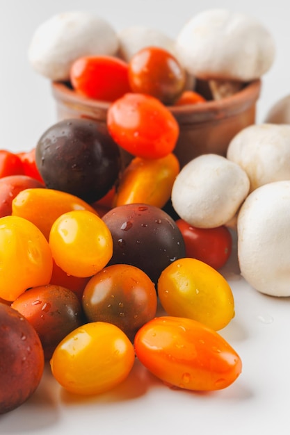 Photo des tomates et des champignons colorés isolés sur un fond blanc