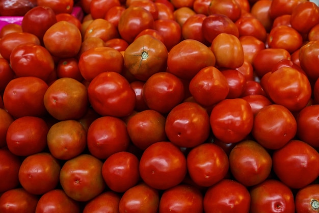 Photo tomates dans une boîte placée sur une étagère à vendre sur un marché