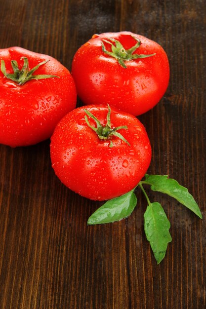 tomates fraîches sur fond en bois.