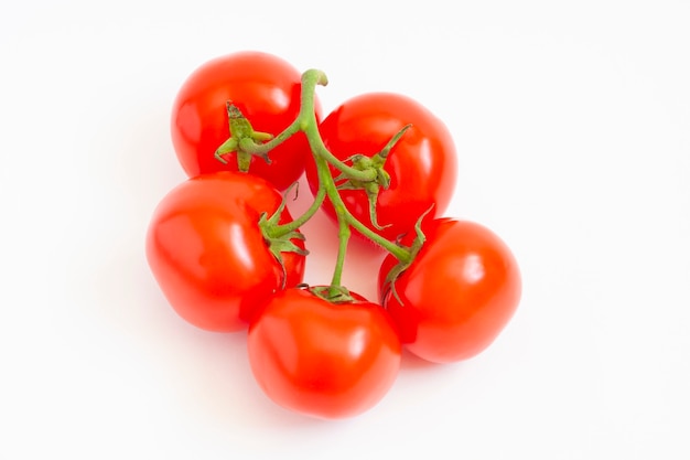 Tomates rouges sur une branche, isolé sur blanc