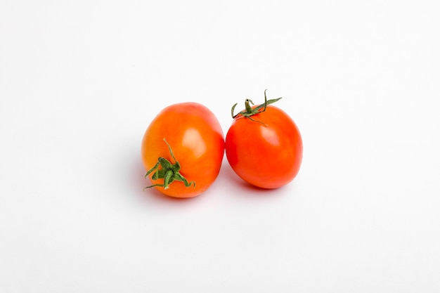 Tomates rouges, brillantes, juteuses et fraîches isolées